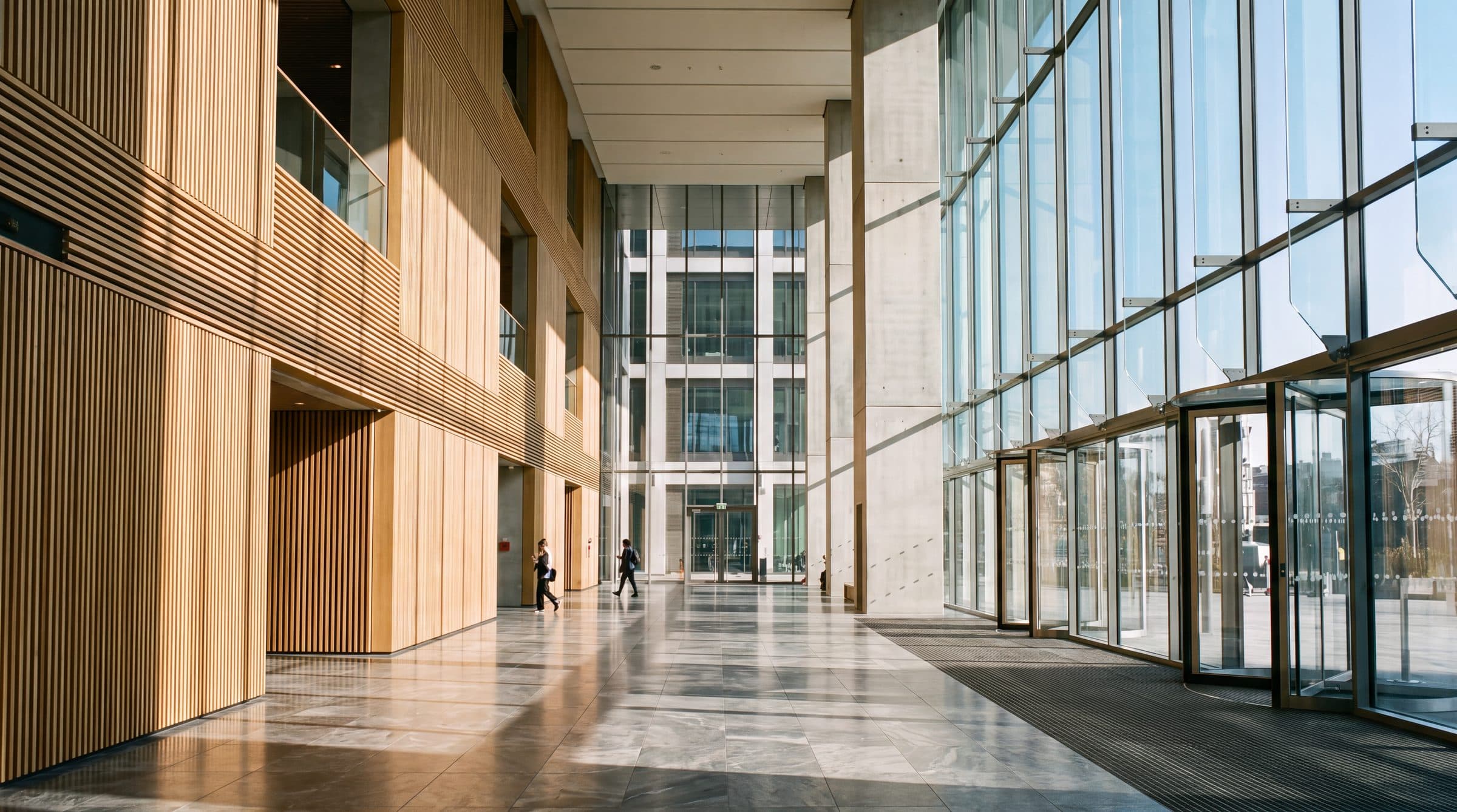 A bright office lobby with timber walls and full-height windows