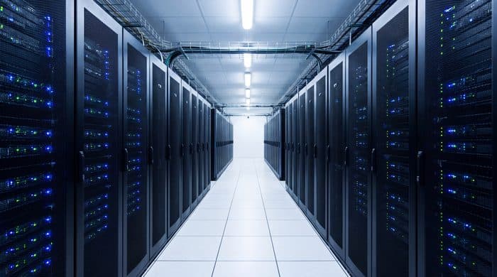 An aisle between rows of servers in a data centre